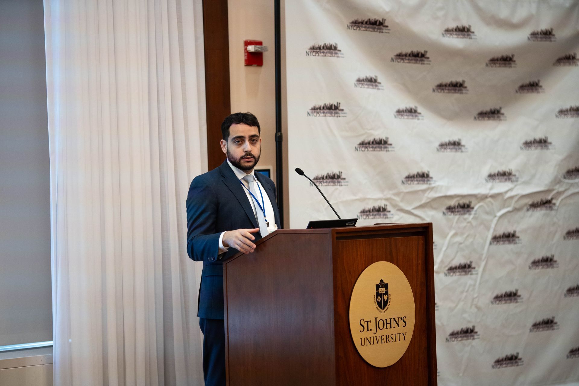 Speaker presenting from the St. John's University podium