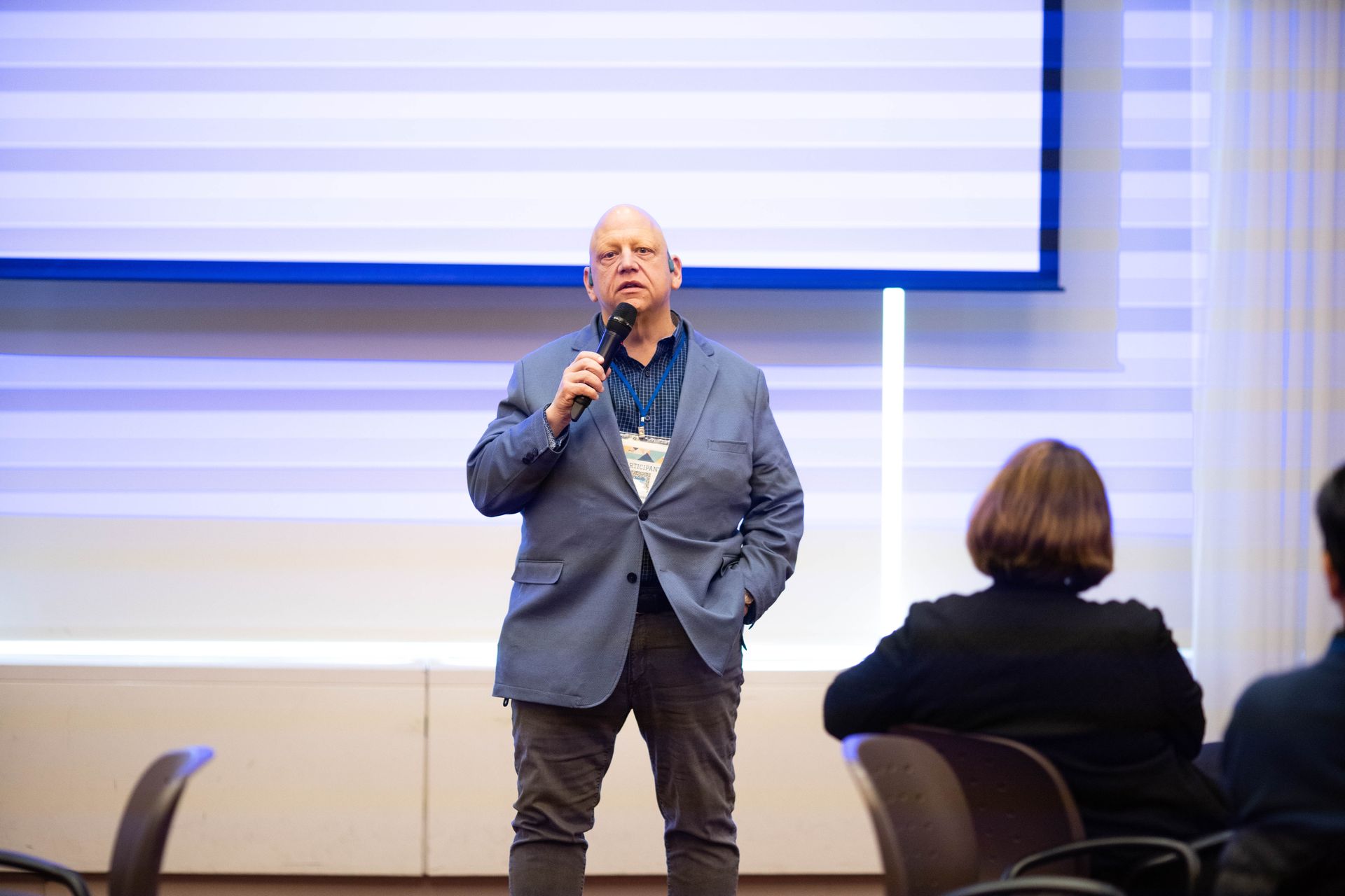 Speaker with a microphone addressing the audience