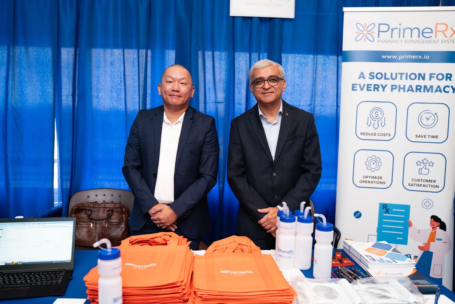 Exhibitors at a pharmacy software booth