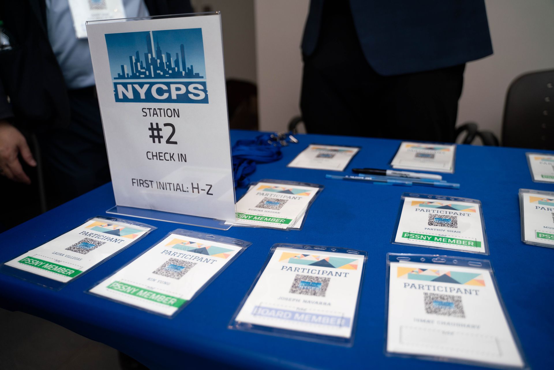 Registration table with NYCPS check-in signs and name badges