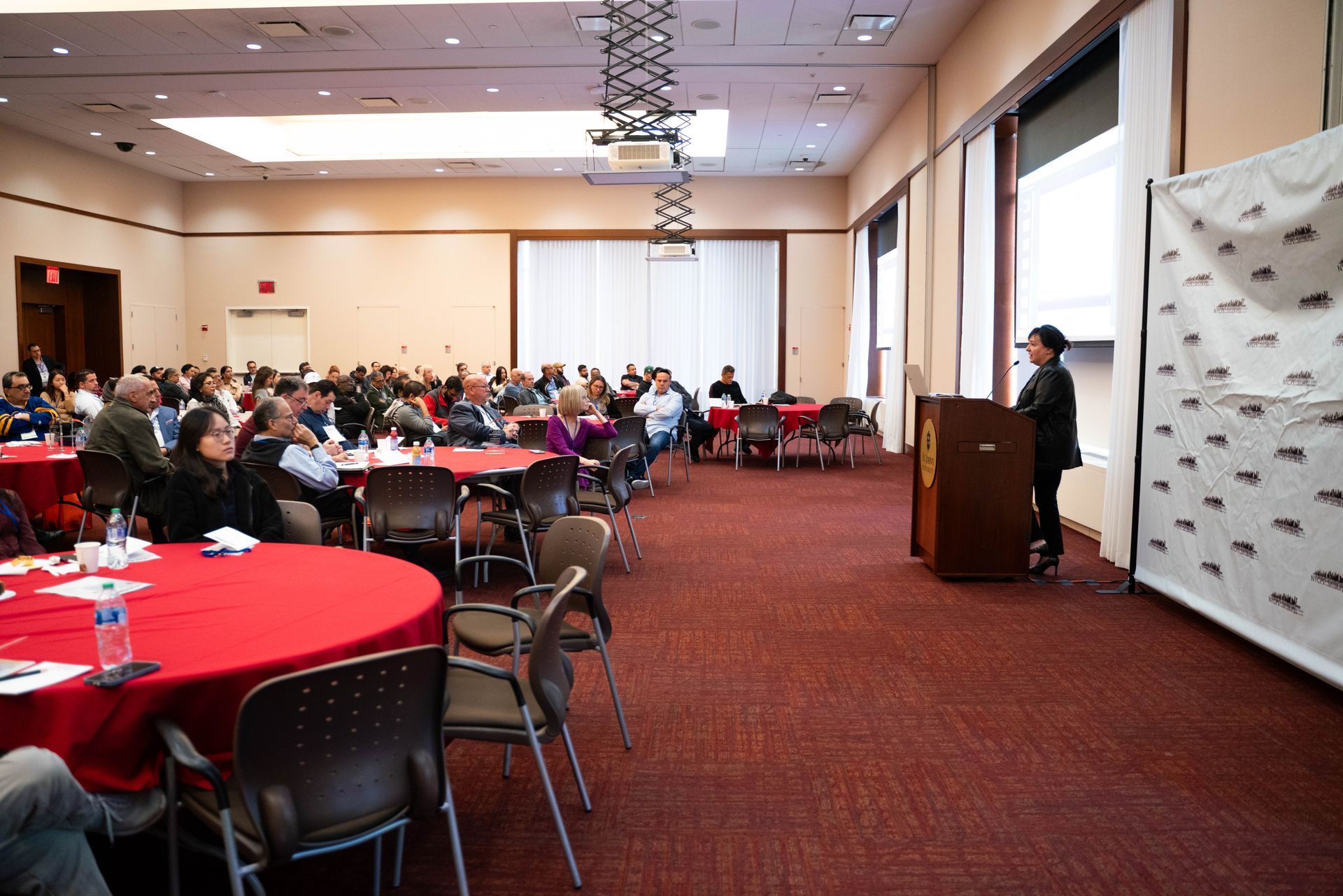 Wide view of the conference room filled with attendees