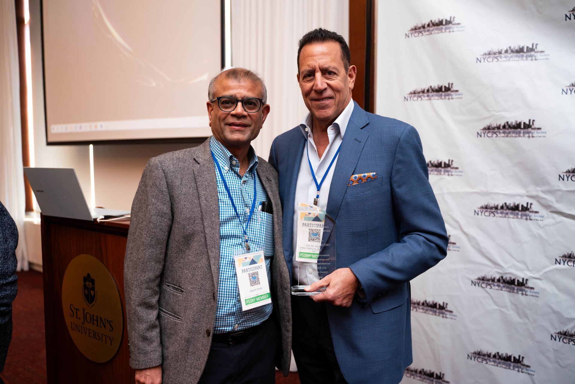 Two colleagues posing together at the event