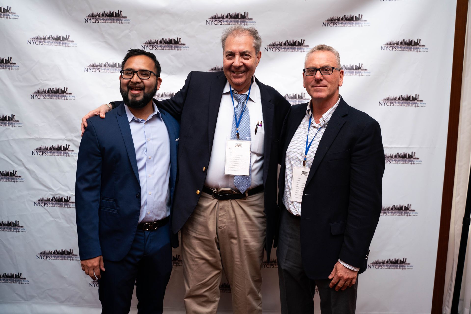 Three guests posing at the photo wall